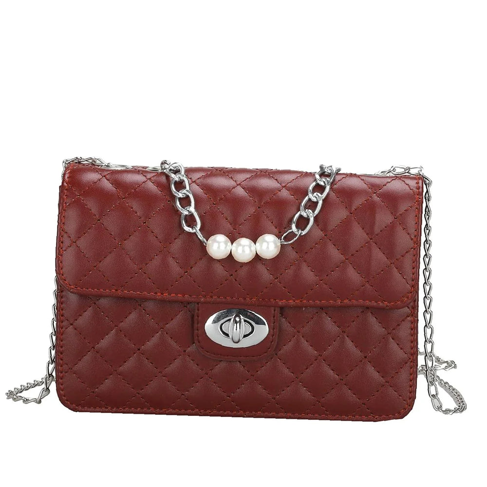 
                      
                        Be elegant with our quilted square bag with flap and twist closure decorated with pearls
                      
                    